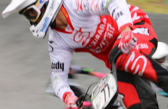 BMX racer in motion showcasing Planett Active Range near Sakakibara Siblings Sign