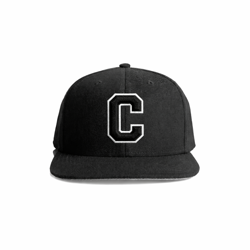 Black snapback cap with a bold white embroidered letter ’c’ on the front.