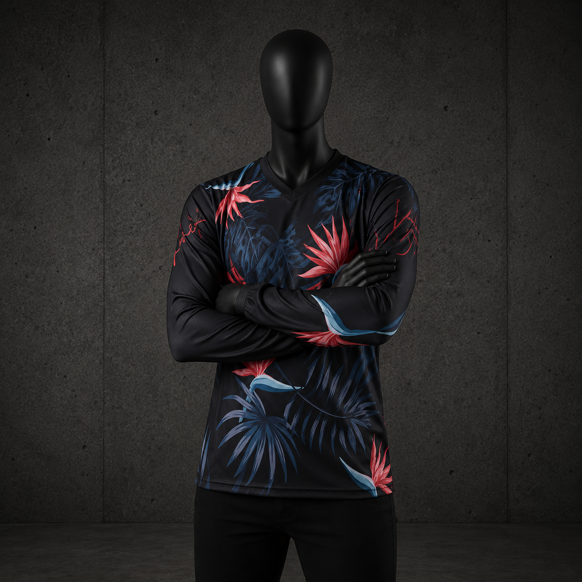 A mannequin wearing a long-sleeve V-neck athletic shirt with a dark tropical floral print in red, blue, and black, posed against a dark gray concrete-textured background.