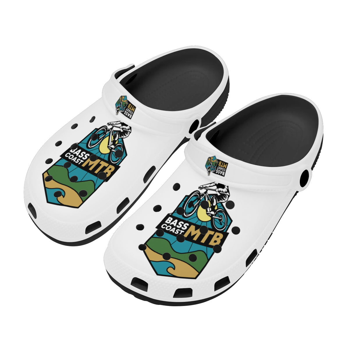 Pair of white clogs with a colorful graphic design featuring a mountain biker and landscape elements.