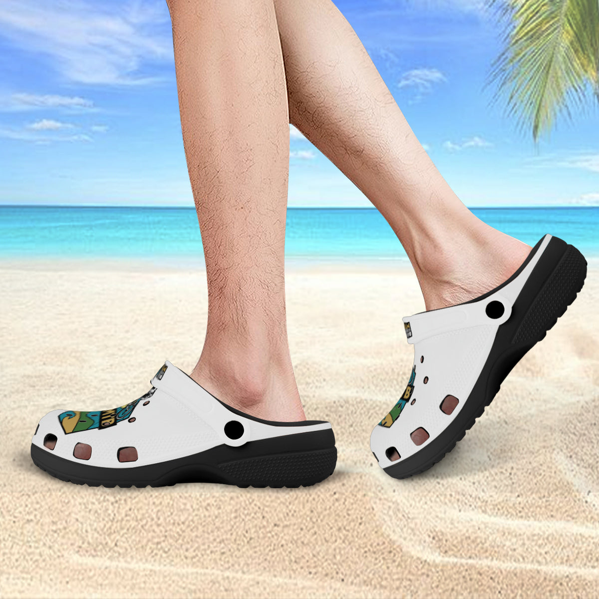 White and black clogs with colorful abstract pattern on a personβs feet.