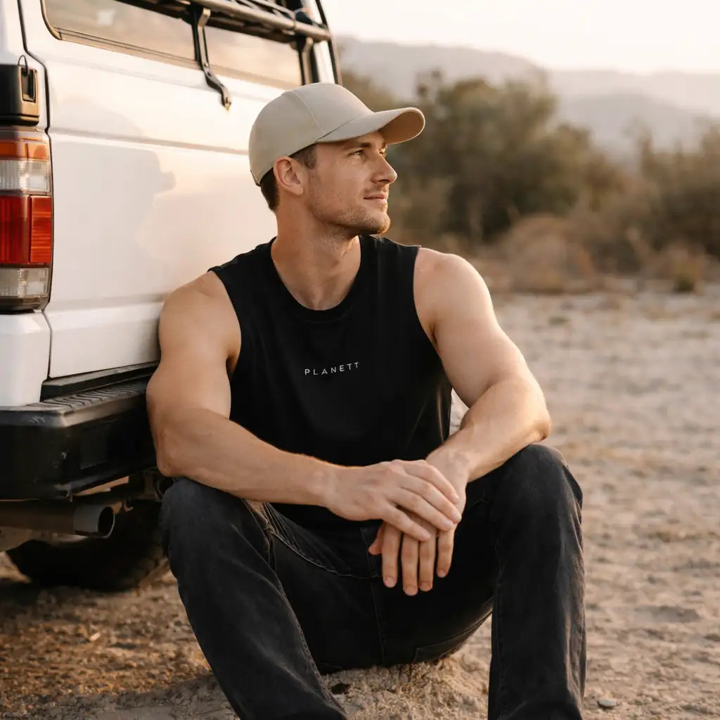 Black sleeveless tank top with ’planett’ printed in white across the chest.