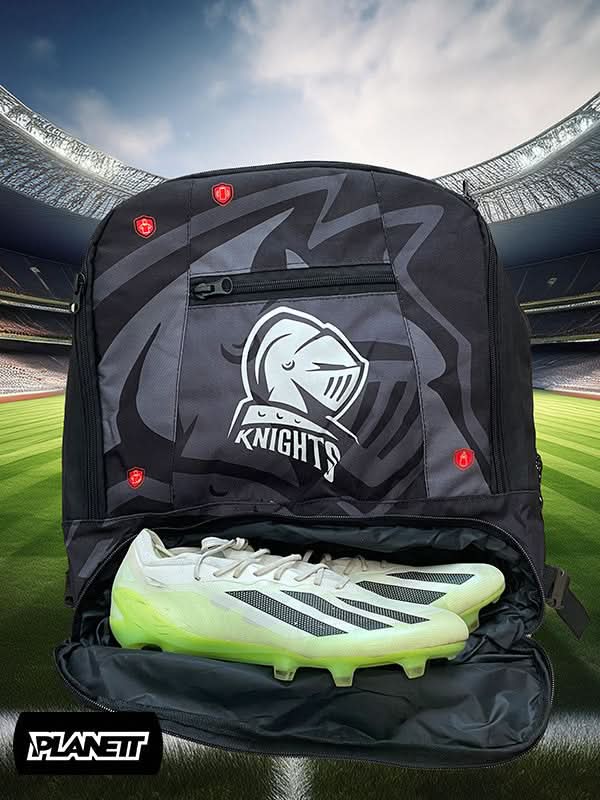 Black sports backpack with a knight’s helmet logo and a pair of white and neon green soccer cleats.