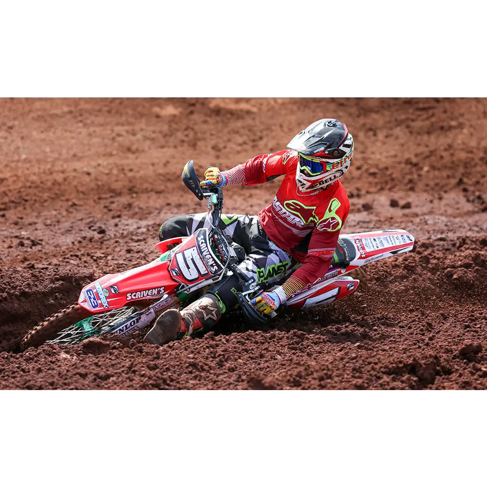 Motocross rider on a red and white dirt bike.