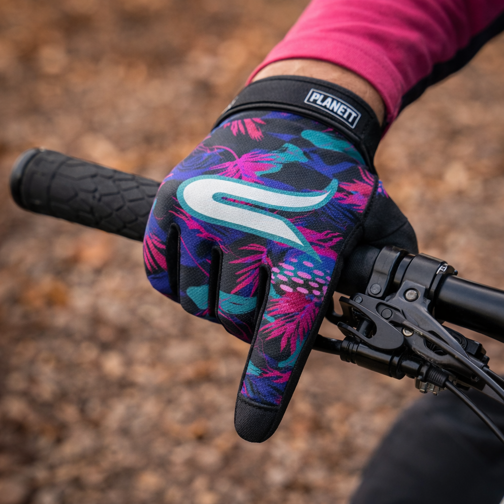 Vibrant floral-patterned planet bike gloves in black, pink, and teal with a white logo on the back of the hand.