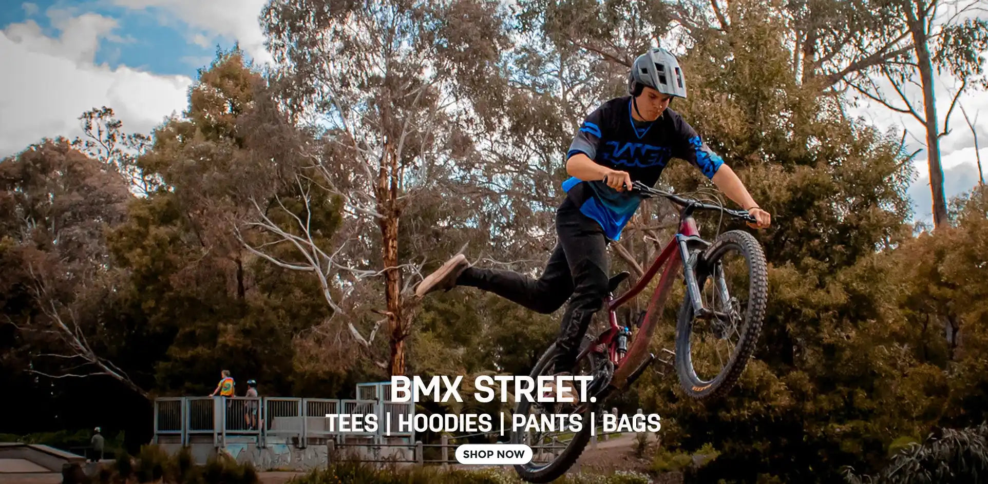 A male rider performing a mid-air trick on a BMX bike.