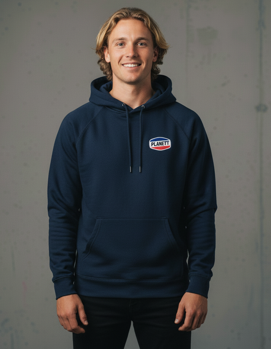 A smiling man in a navy blue hooded sweatshirt with a small, colorful logo on the chest.