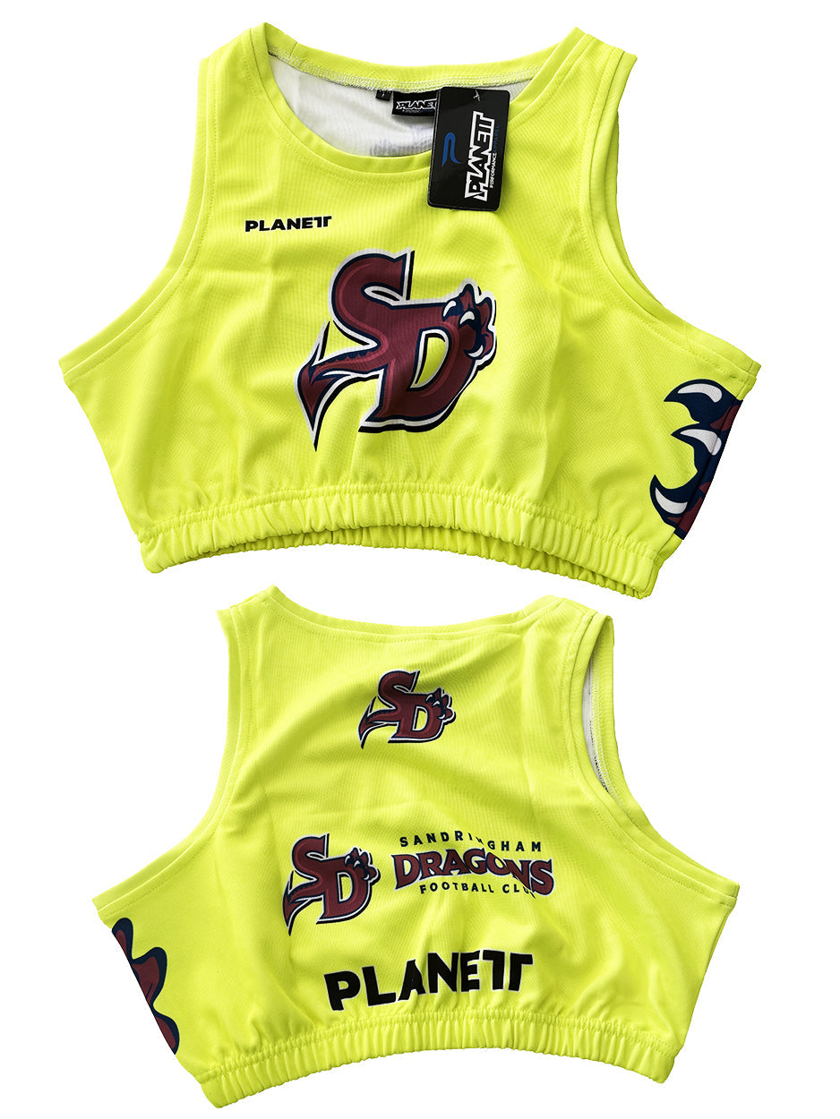 Two bright yellow sports bras, one showing the front with a ’SD’ logo and a tag, and the other showing the back with ’SANDRINGHAM DRAGONS FOOTBALL CLUB’ text.
