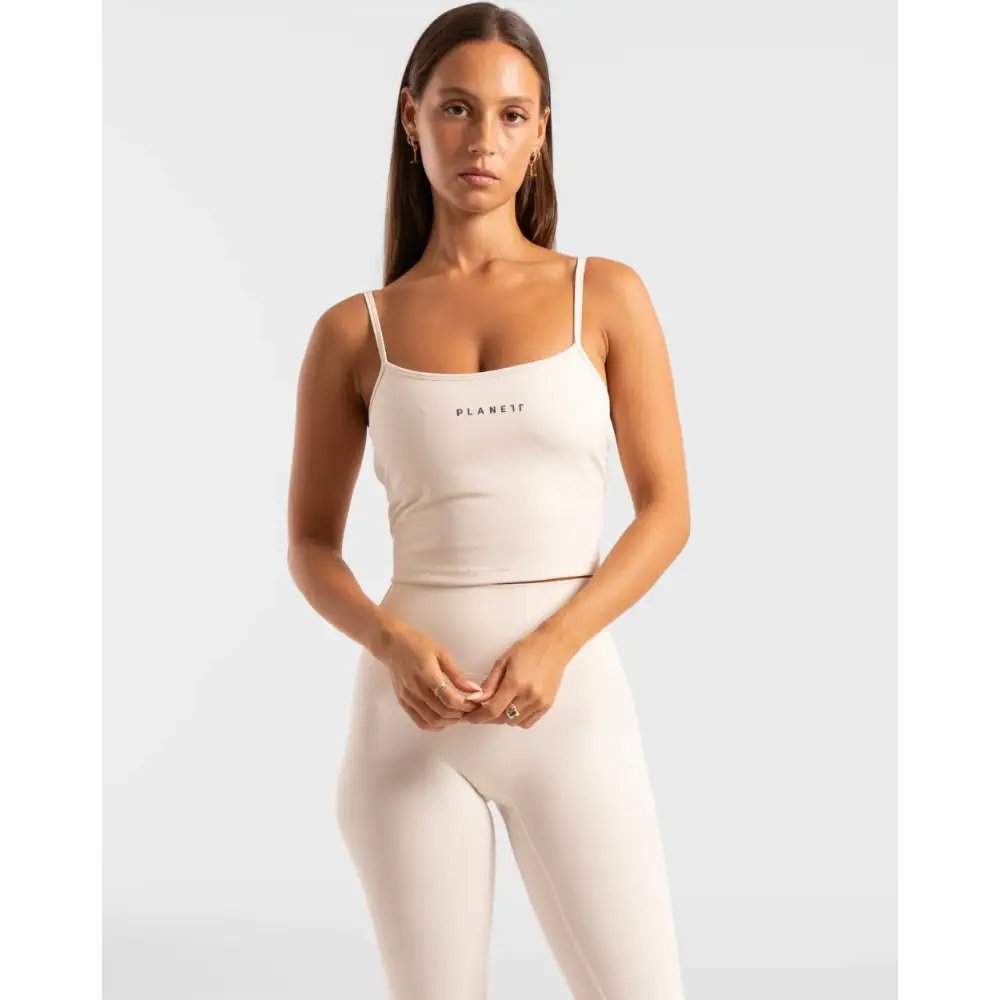 Beige athletic top and leggings set.