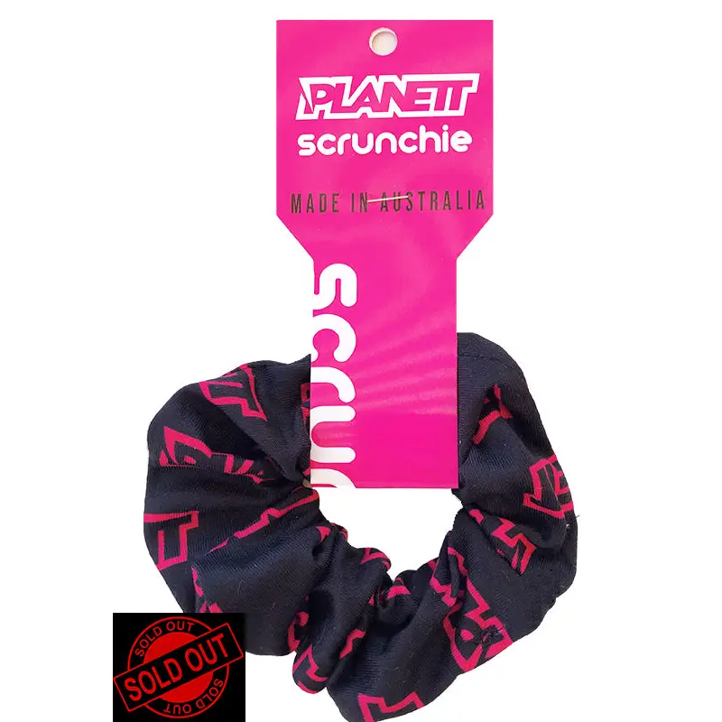 Black and pink patterned scrunchie with tag.