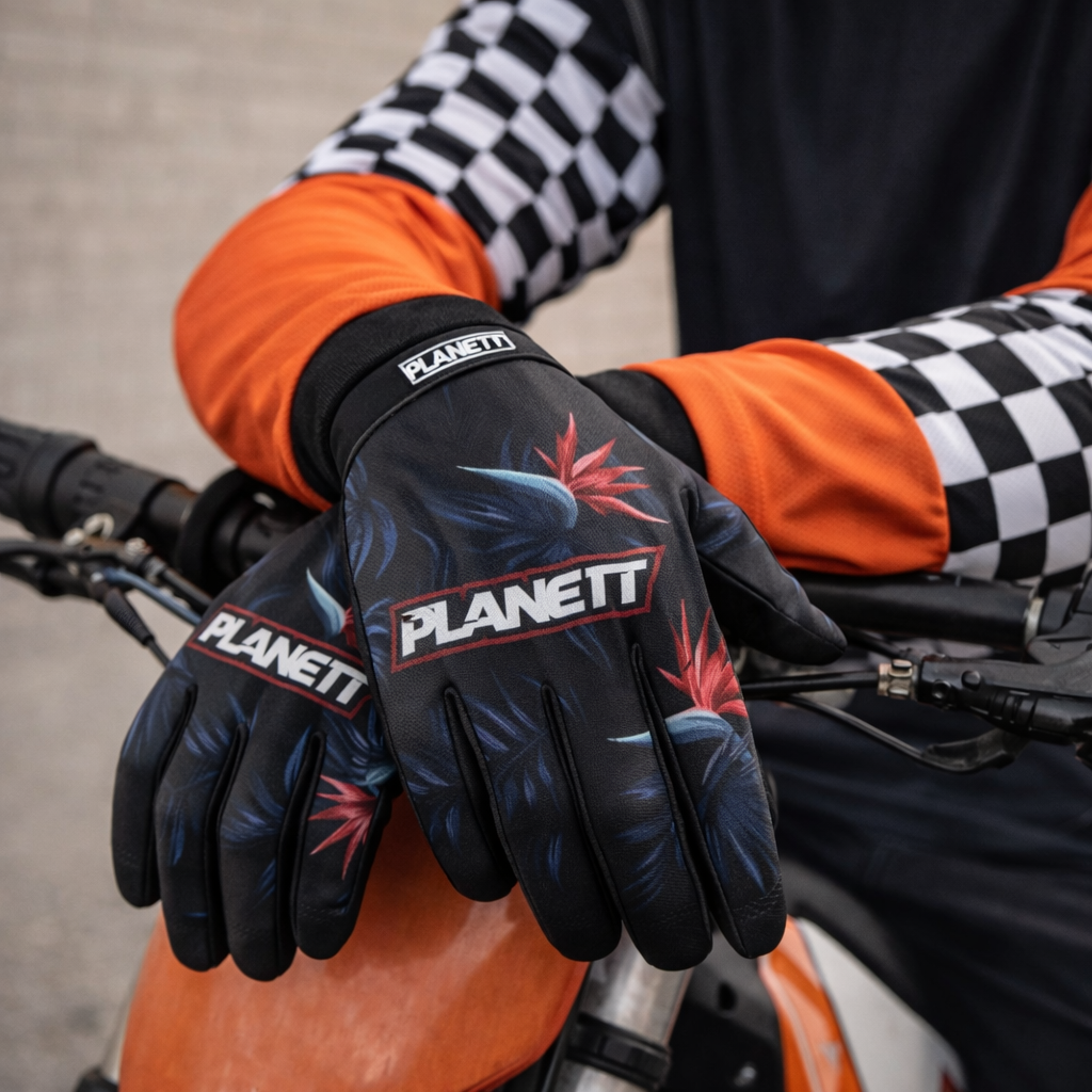 Black planett motorcycle gloves with vibrant red and blue tropical bird graphics.