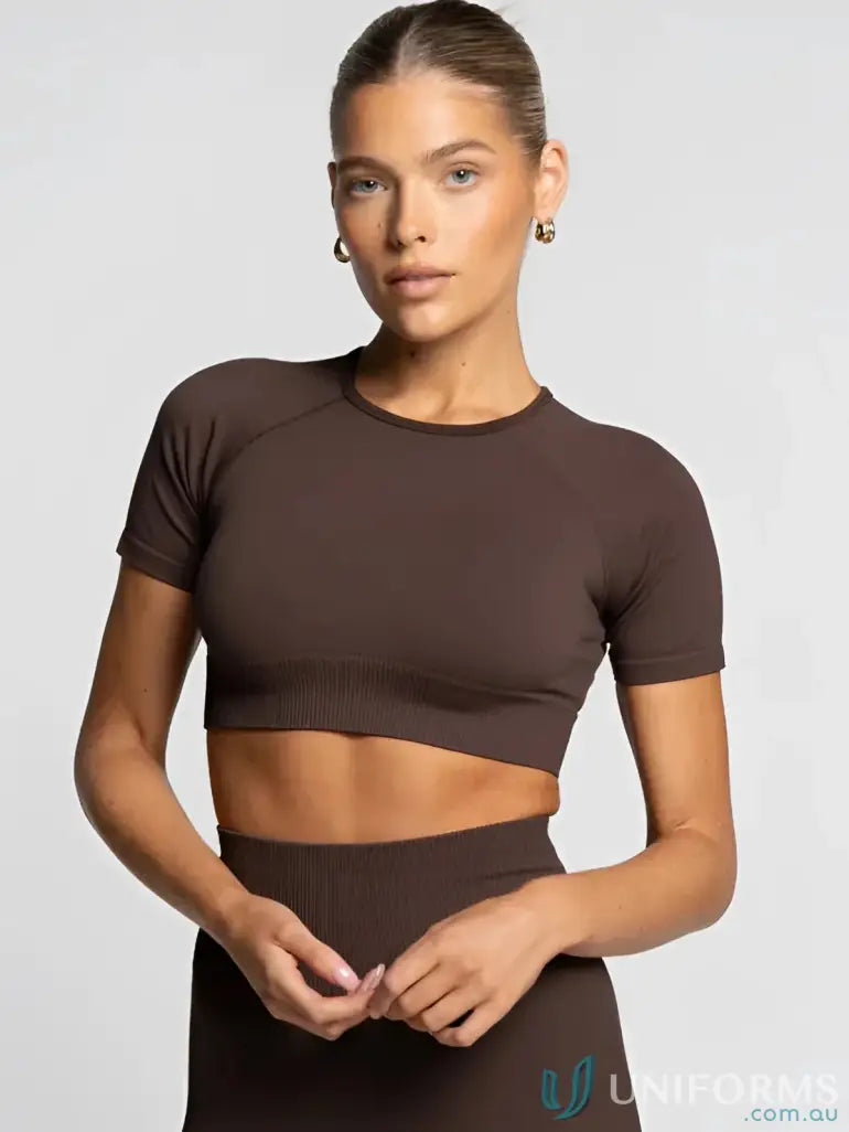 Brown cropped athletic top with short sleeves and round neckline.