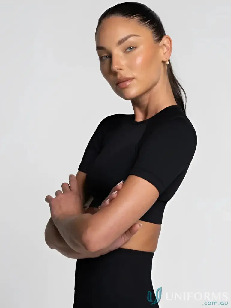 Black cropped top with short sleeves and round neckline.