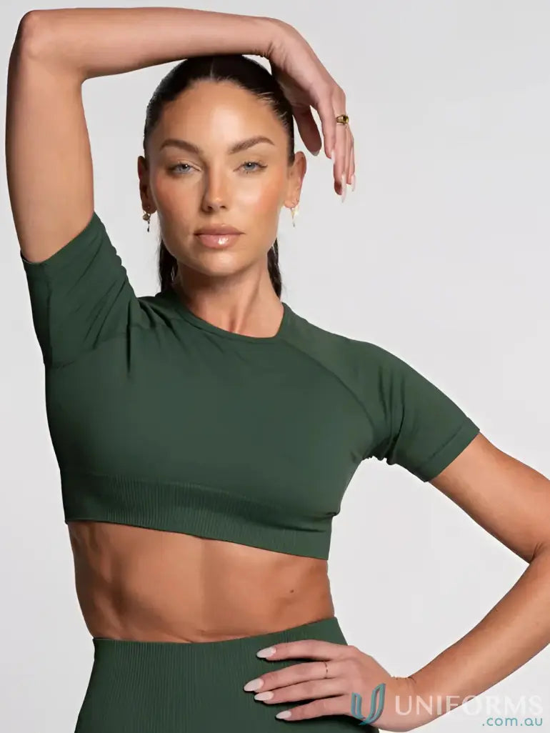 Olive green cropped athletic top with short sleeves and ribbed hem, likely made of stretchy fabric.