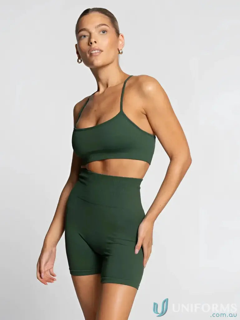 Green seamless athletic set with high-waisted shorts and a sports bra, suitable for fitness activities.