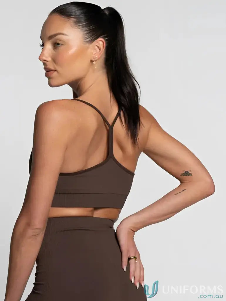 Brown strappy crop top with cutout design and high-waisted skirt set.