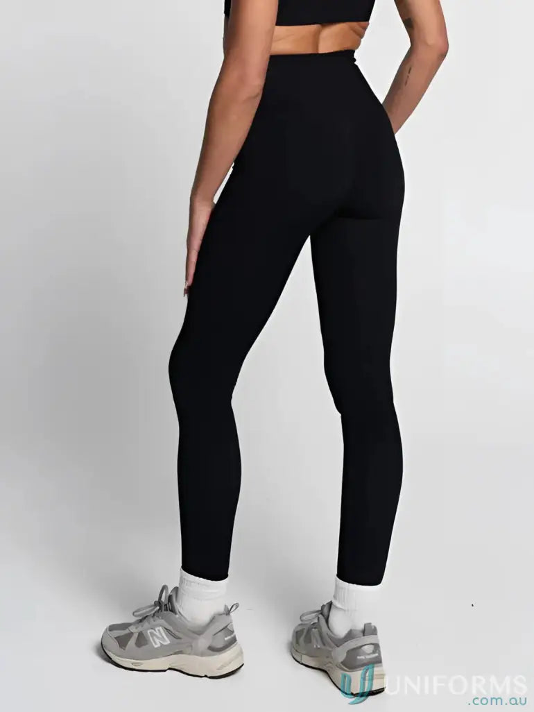 Black leggings with high waistband and white socks.