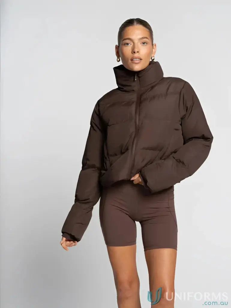 Brown puffer jacket with high collar and zipper detail, made of synthetic material.