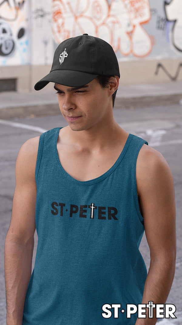 Man wearing a tank top and baseball cap.