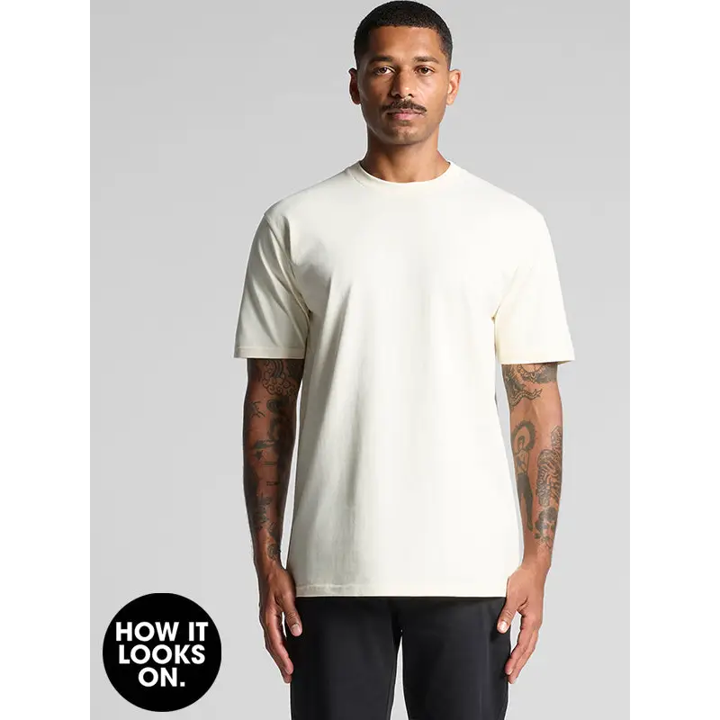 Man wearing a cream-colored t-shirt.