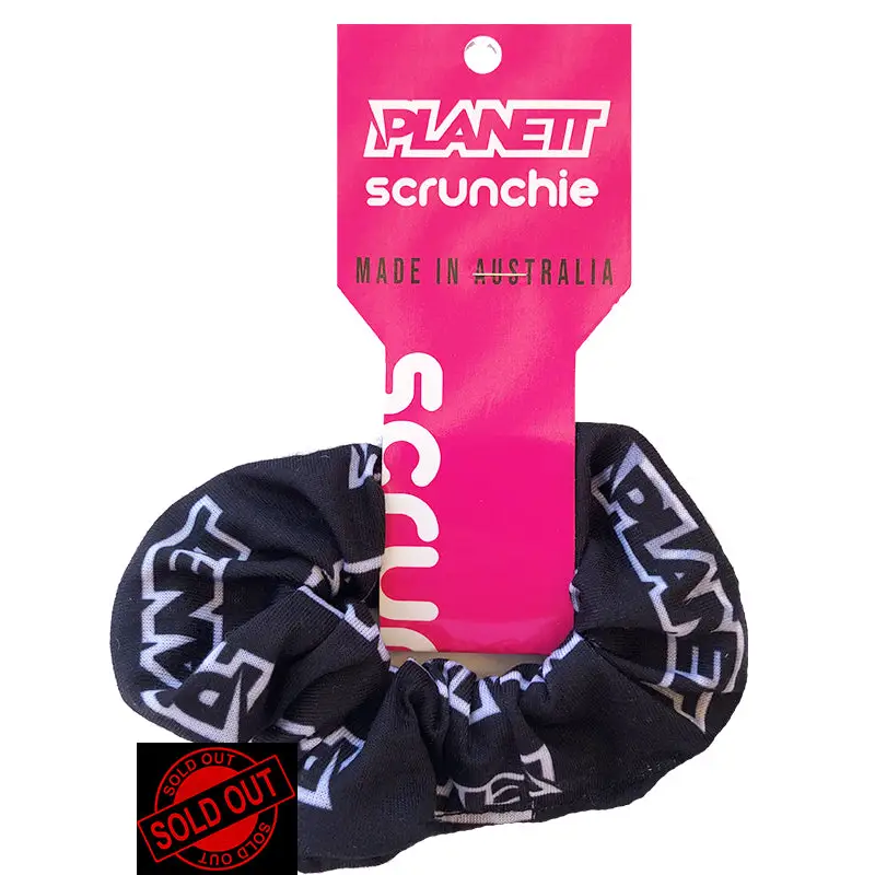 Black and white patterned scrunchie with pink tag.