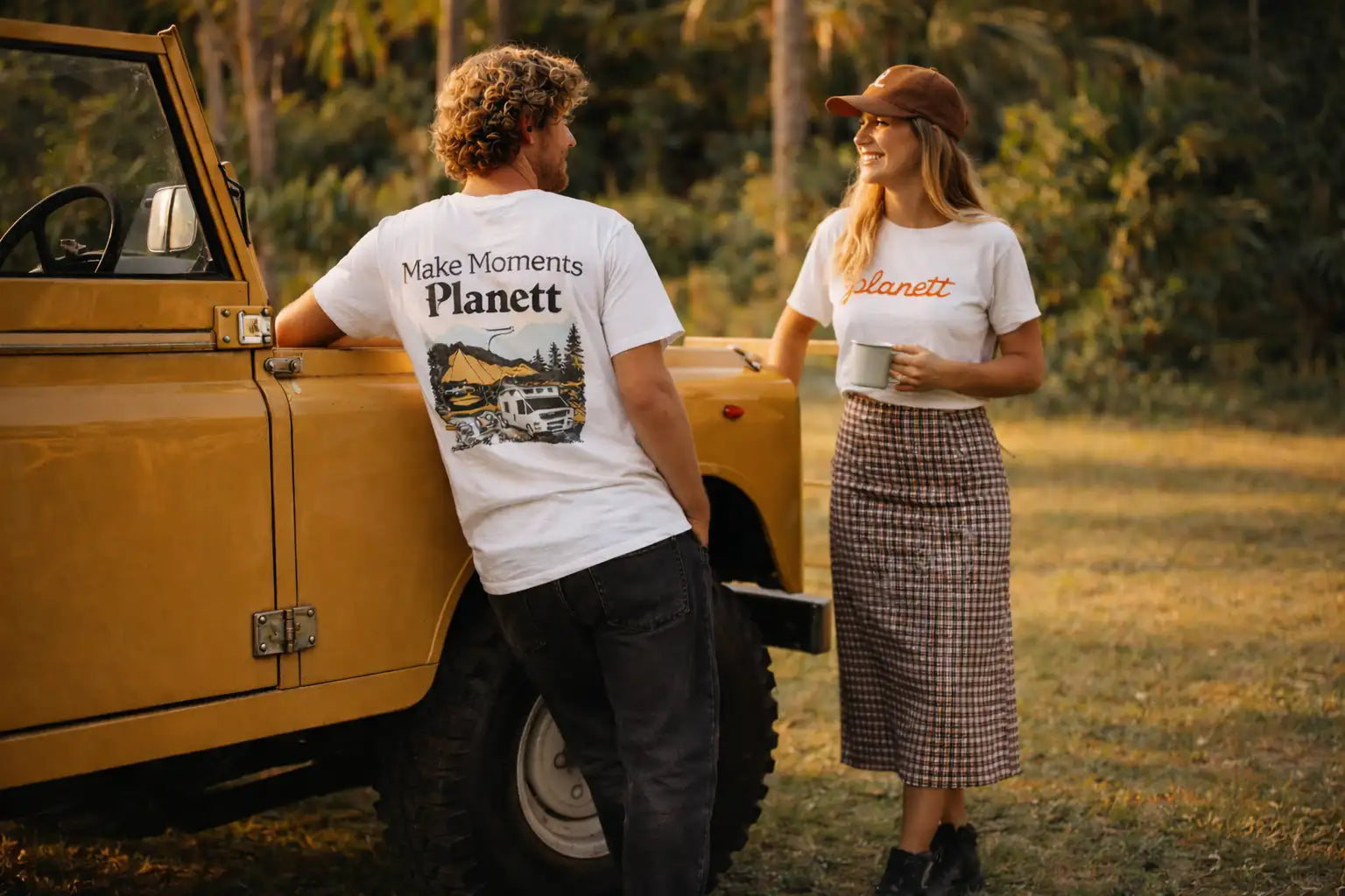 White t-shirt with ’make moments planet’ text and a vintage truck graphic on the back.