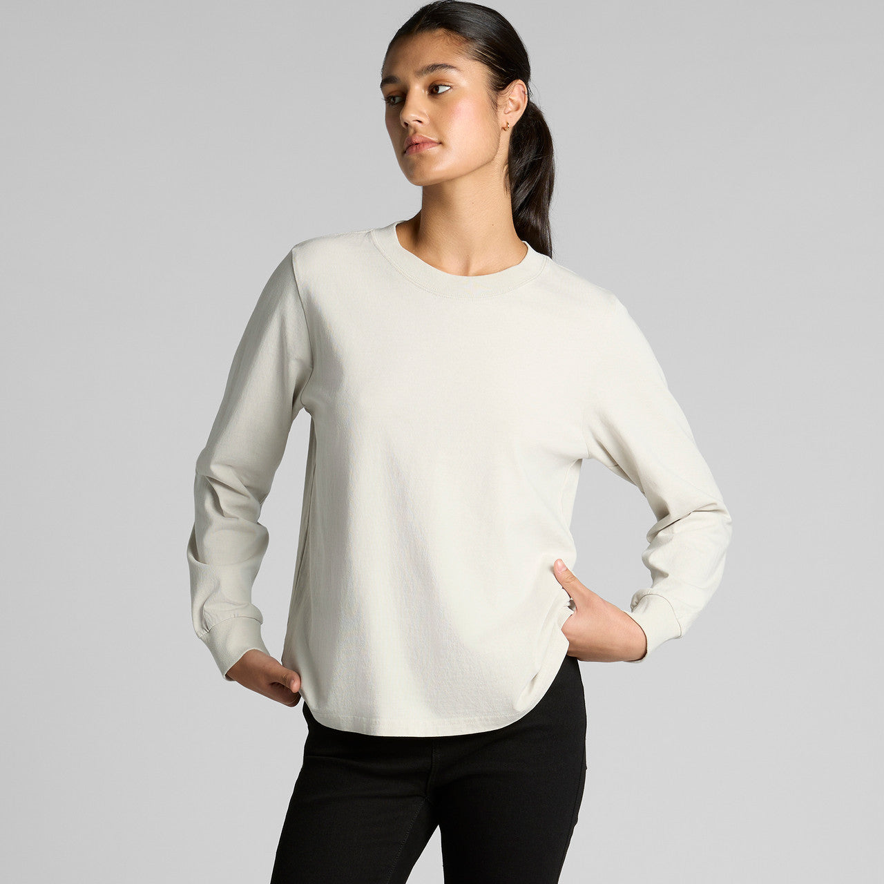 Cream-colored long-sleeved sweatshirt with ribbed cuffs and hem, black leggings.