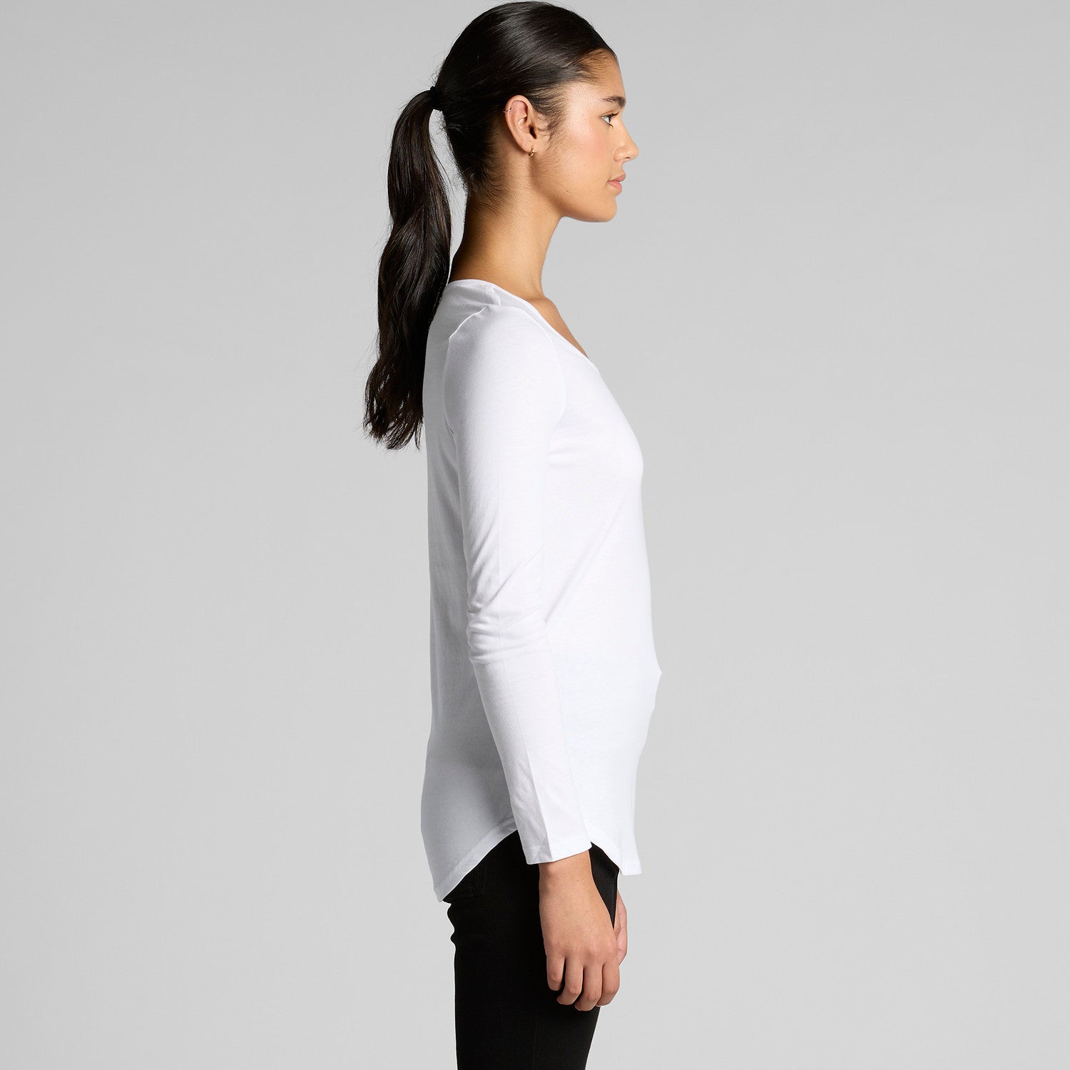 White long-sleeved t-shirt with a high-low hem and black leggings.