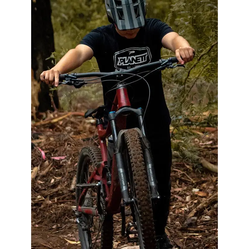Red mountain bike with front suspension.