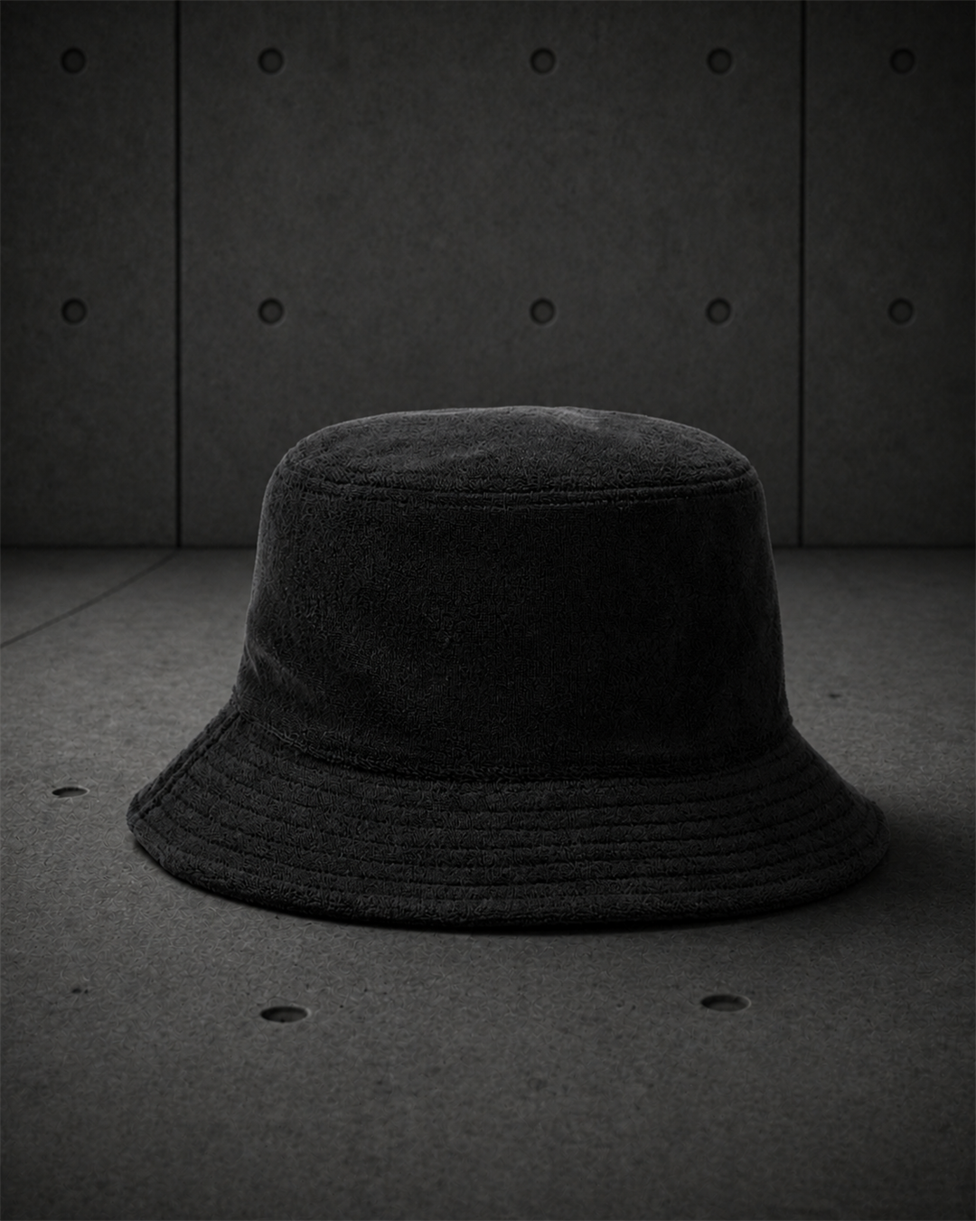Terry Bucket Hat 1175 blank product on dark industrial concrete background