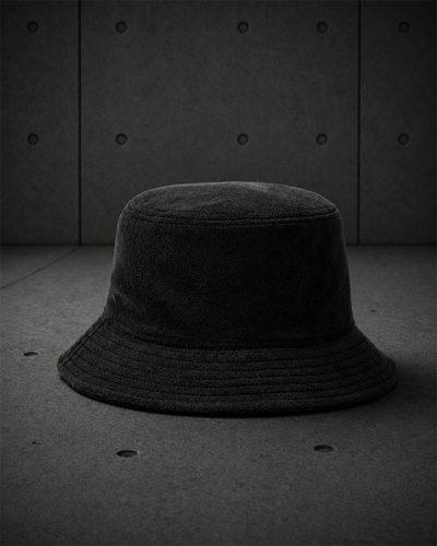 Terry Bucket Hat 1175 blank product on dark industrial concrete background