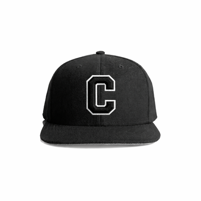 Black snapback cap with a bold white embroidered letter ’c’ on the front.