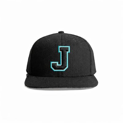 Black snapback cap featuring a bold, teal-outlined embroidered letter ’j’ on the front.