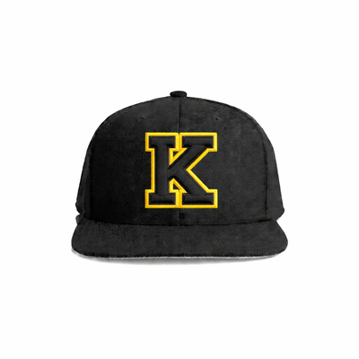 Black suede snapback cap featuring a bold yellow embroidered ’k’ logo.