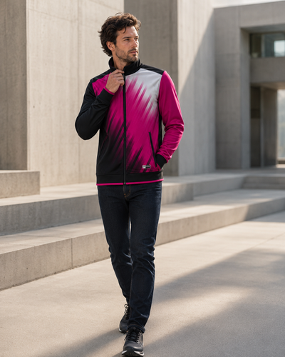 Man wearing a colorful jacket walking outdoors in front of a modern building.