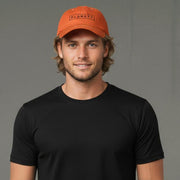 An orange baseball cap with a black rectangular logo.