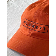 Orange baseball cap.