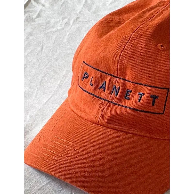 Orange baseball cap.