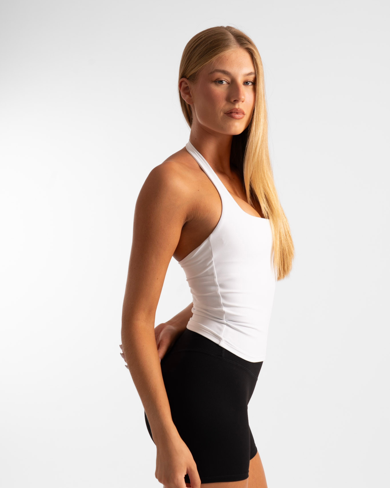 White tank top with black shorts and high-waisted design.
