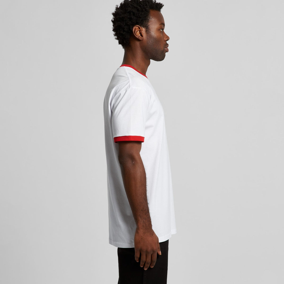 White and red short-sleeved jersey shirt with black pants.