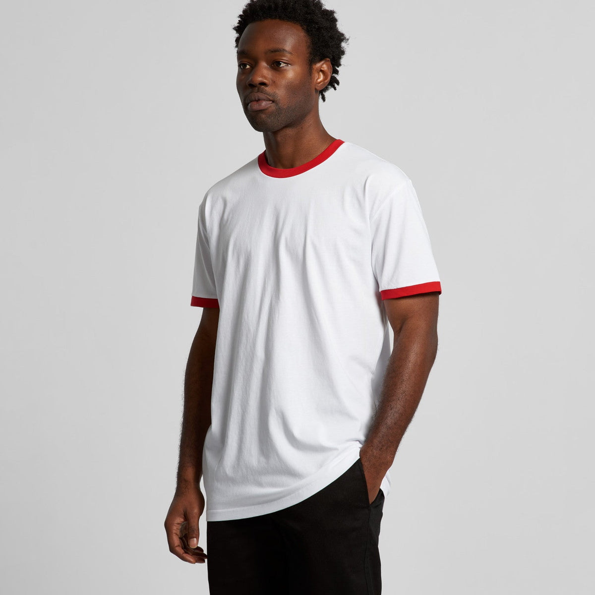 White and red ringer t-shirt with black pants.