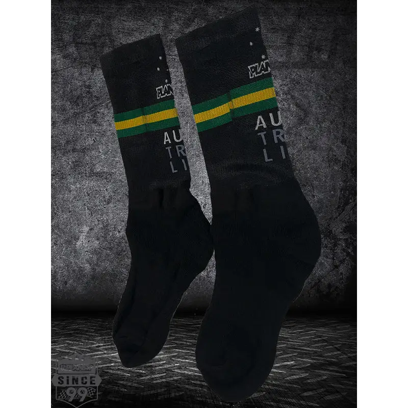 Pair of black socks with green and gold stripes.