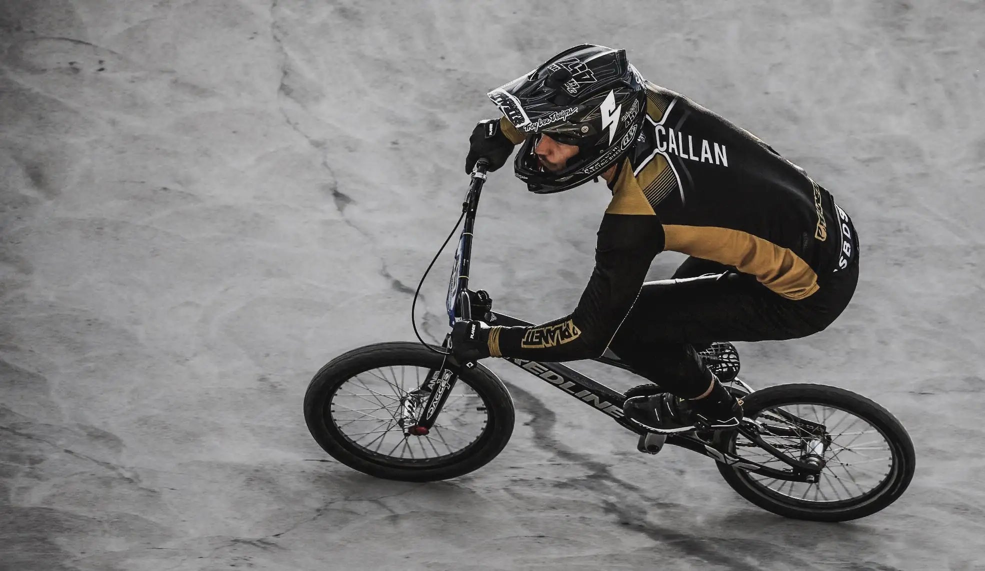 Black and gold bmx bike with ’redline’ branding on the frame