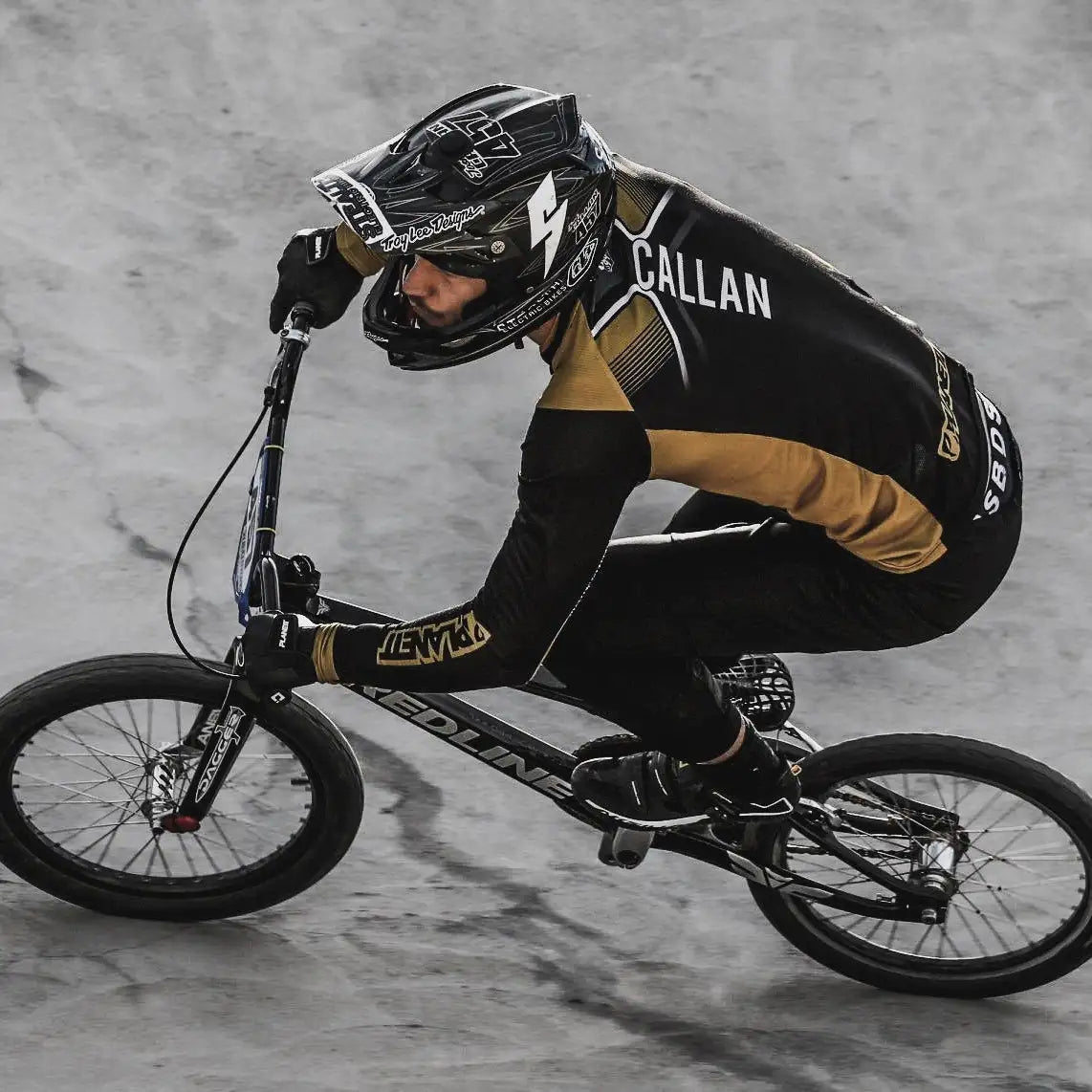 Black and gold bmx bike with ’redline’ branding on the frame.