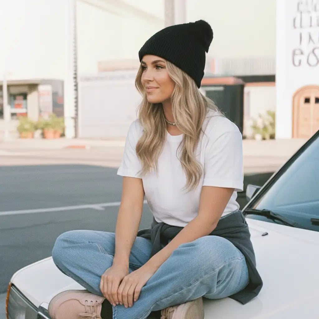 Black beanie with ribbed texture and knit material.