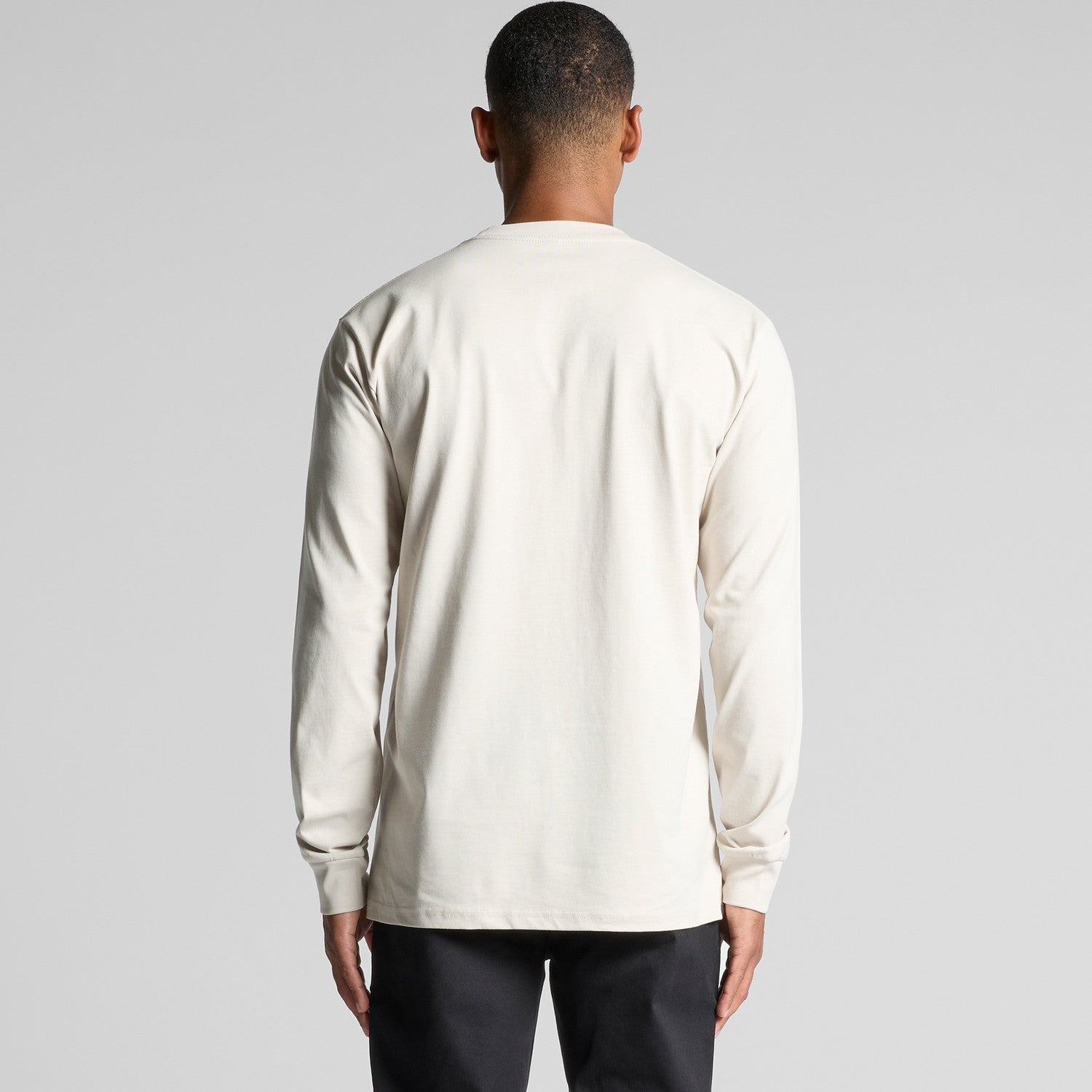 Cream-colored long-sleeved crew neck t-shirt with a pocket on the back.