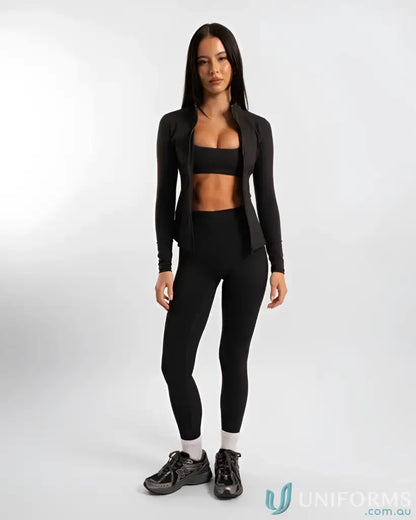 Black leggings with a high waist and ribbed texture, paired with a matching long-sleeve crop top.