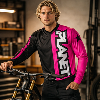 Bright pink and black long-sleeved motocross jersey with bold ’planet’ branding.