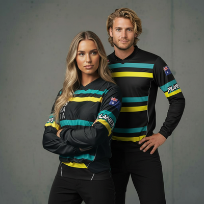 Two athletes in matching black, yellow, and green striped long-sleeved athletic shirts.