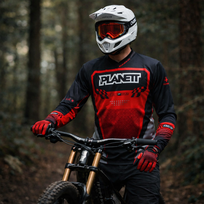 White helmet with orange-tinted goggles and black straps, featuring a sleek design for mountain biking.